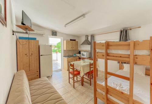 a room with two bunk beds and a kitchen at Amazona Apartments and Studios in Spartià