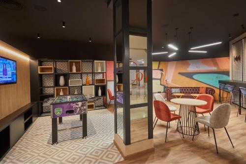 a rendering of a childrens play room with a table and chairs at Dreams Lanzarote Playa Dorada Resort & Spa in Playa Blanca