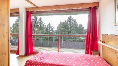 a bedroom with red curtains and a large window at V du Bachat Asters B21 - Appt 6 pers in Chamrousse