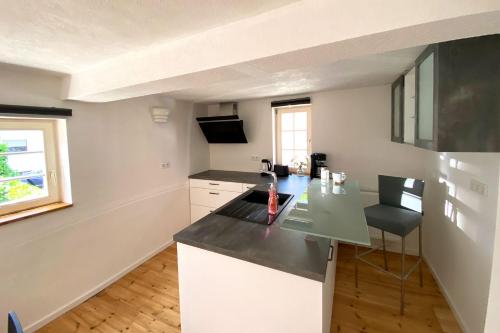 a kitchen with white cabinets and a counter top at Nice Apartment in Eschborn in Eschborn
