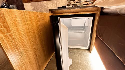 a small refrigerator with its door open in a kitchen at Sakura Bella Ikebukuro in Tokyo