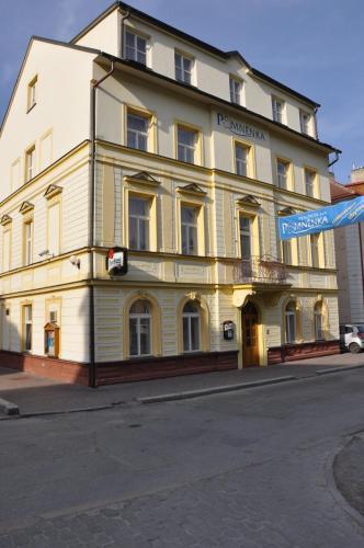 a large white building on the corner of a street at Penzion Pomnenka in Luhačovice