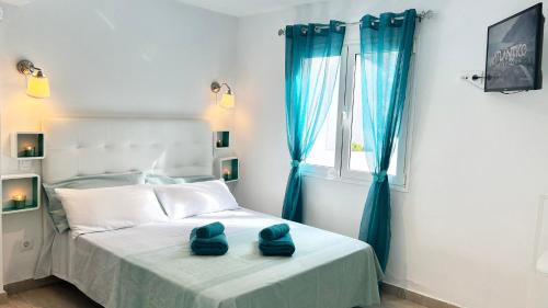 a bedroom with a bed with blue towels on it at Arthouse Sea View - Acquamarina e Zaffiro in Puerto del Carmen