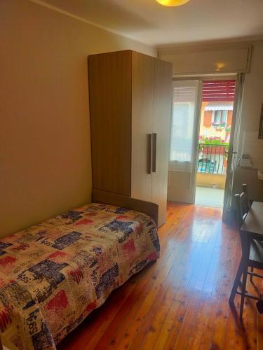 a bedroom with a bed and a wooden floor at Locanda Da Tullio in Capovalle