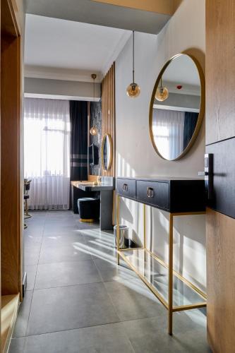 a bathroom with a blue vanity and a mirror at Buyuk Truva Hotel in Canakkale