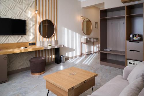 a living room with a couch and a table at Buyuk Truva Hotel in Canakkale