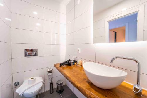 a white bathroom with a sink and a mirror at Kamkat Otel in Kemer