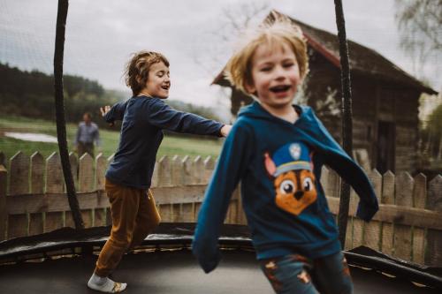 two young boys playing on a swing at Jurty z widokiem, prywatna balia- DZIKOLAS GLAMPING in Krasnobród