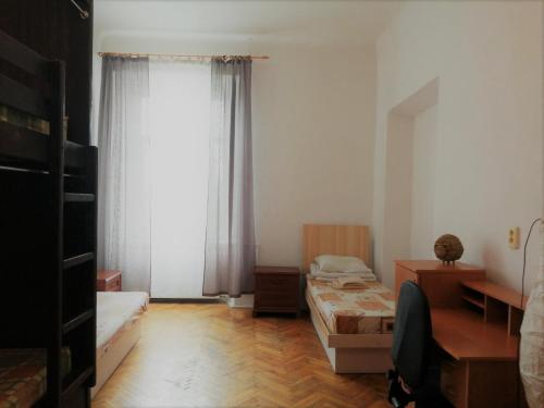 a small room with two beds and a window at Coffee Home Hostel in Lviv