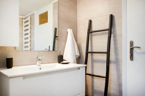 ein Bad mit einem Waschbecken und einem Spiegel in der Unterkunft Luxury Apartment with Exceptional View in Athen