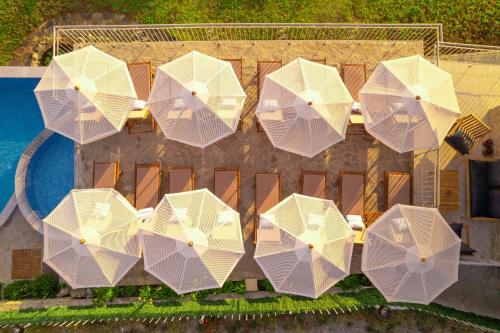 an overhead view of white umbrellas next to a pool at DOLPHIN BAY BOUTIQUE COMPLEX Sozopol in Sozopol