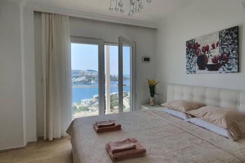 a bedroom with a large bed with a large window at MAGNIFICENT VIEW with Private Pool & Piano, 3 Bedroom Villa, MIN 4 nigths in Gundogan