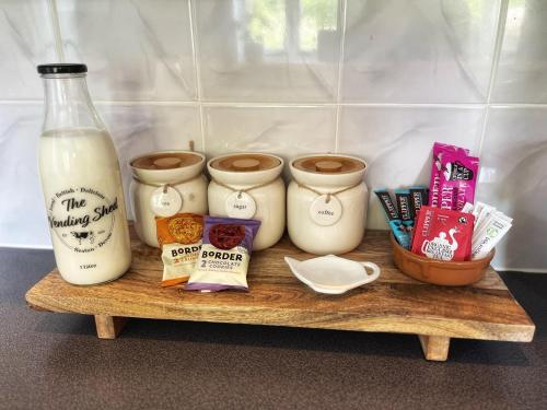 a shelf with a bottle of milk and some food at The Old Chapel in Axminster