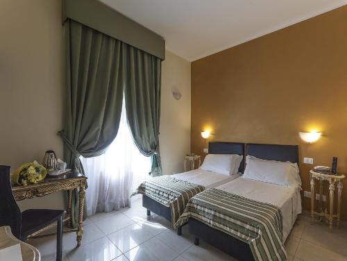 a bedroom with a bed and a large window at Hotel Regina Giovanna in Rome