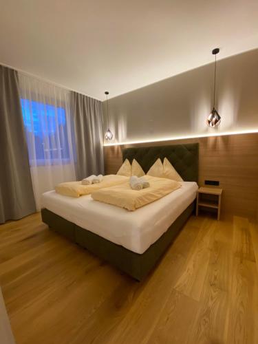 a bedroom with a large bed with lights on it at Ferienhaus Petra in Sankt Kanzian