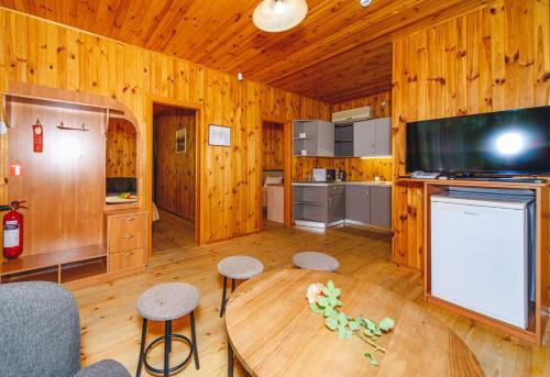 a kitchen with a table and a tv in a cabin at Sovinyon Resort in Odesa