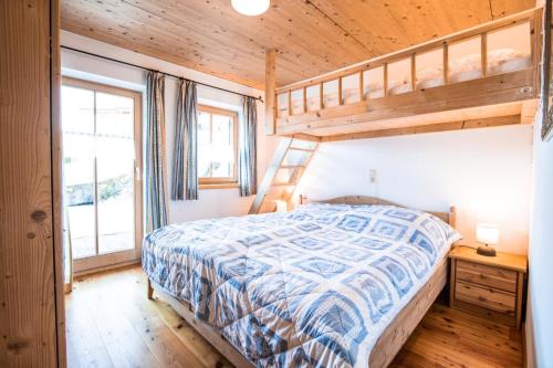 a bedroom with a bed and a bunk bed at Ferienhaus Königsleiten 175 in Königsleiten