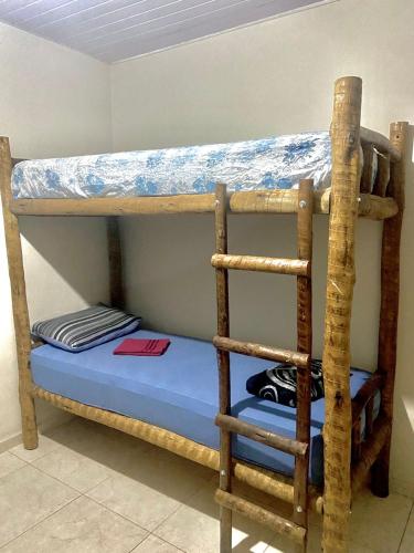 two bunk beds in a room with a blue mattress at Casa top aeroporto in Macaé