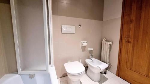 a bathroom with a toilet and a shower and a sink at Locanda Al Volo Tommaseo in Trieste