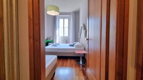 a small room with a bed and a window at Locanda Al Volo Tommaseo in Trieste