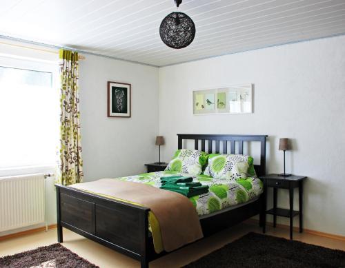 a bedroom with a bed and two tables and a window at Waldblick Landhaus B&B in Schwarzenbach an der Pielach