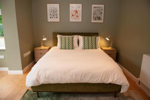 a bedroom with a large bed with two lamps at Brooklands in Lyme Regis
