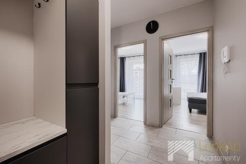 a hallway with a door leading to a living room at Primo V by LookAp in Łódź