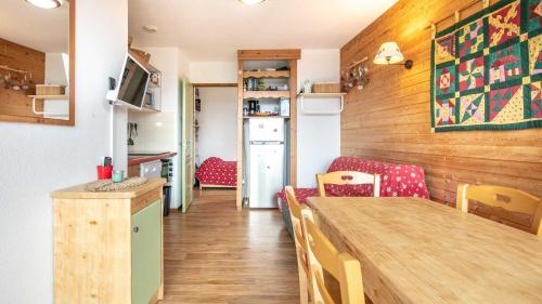 une petite cuisine avec une table et des chaises dans une pièce dans l'établissement V du Bachat Droseras 16 - Appt 4-5 pers, à Chamrousse