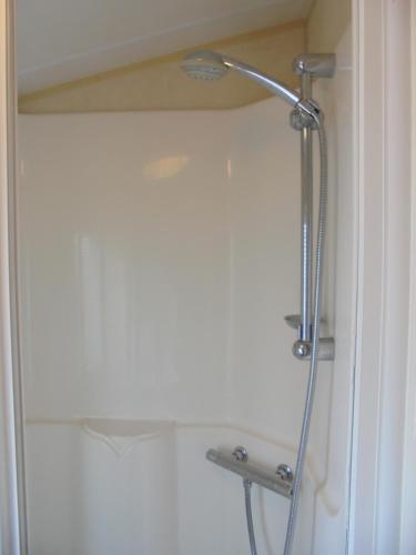 a shower in a bathroom with a shower head at The Grange: Solstice:- 6 berth, enclosed veranda in Ingoldmells