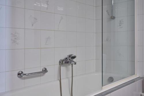 a bathroom with a shower with a glass door at Chic designer home next - Hilton in Athens