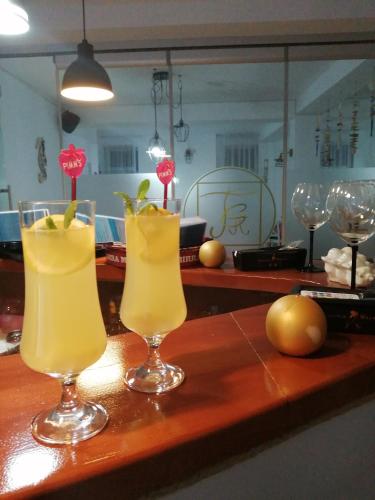 two cocktails in glasses sitting on a table at Tina Guest House in Basarabi