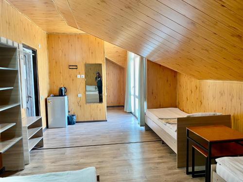 a room with wooden walls and a wooden ceiling at Eram Garden Hotel in Bosteri
