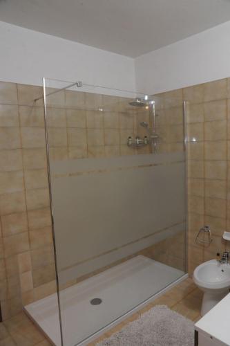 a bathroom with a shower with a sink and a toilet at Locazione turistica aquila bianca in Roccabruna