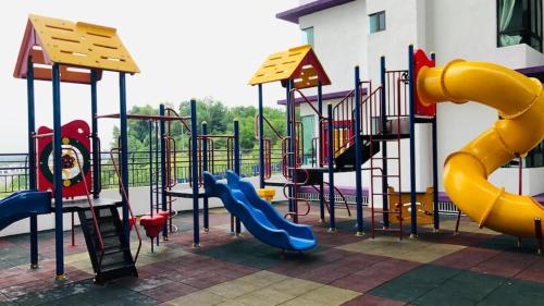 a playground with a slide and a slide at TOP Muzaffar Homestay in Ayer Keroh