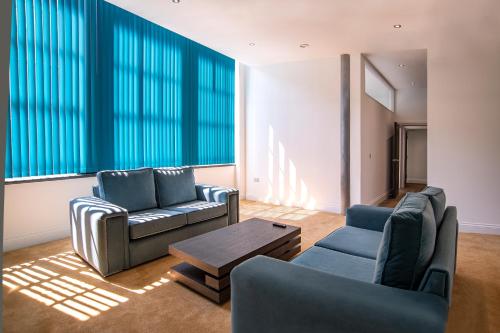 a living room with two couches and a coffee table at The Castle Collection - 5 Union Court in Liverpool