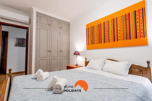 a bedroom with a bed with towels on it at #056 Old Post Office by Home Holidays in Albufeira