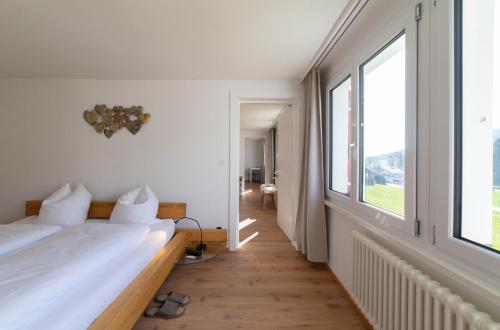 um quarto com 2 camas e uma grande janela em Lisighaus em Wildhaus