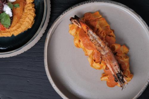 a plate of food with a fish on top at Boni Beach Lombok Boutique Hotel & Villas in Selong Belanak
