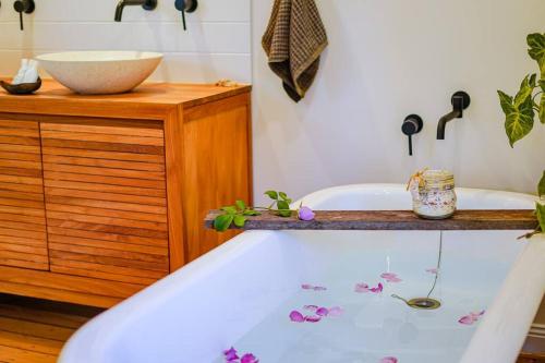 a bathroom with a bath tub with flowers on it at The Rustic Cottage - Canungra in Canungra