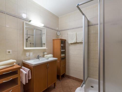 a bathroom with a sink and a shower at Landhaus Maximilian in Hopfgarten im Brixental