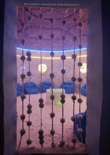 a chandelier in front of a window in a room at Panta Lodge Siwa بنتا لودج سيوة in Siwa
