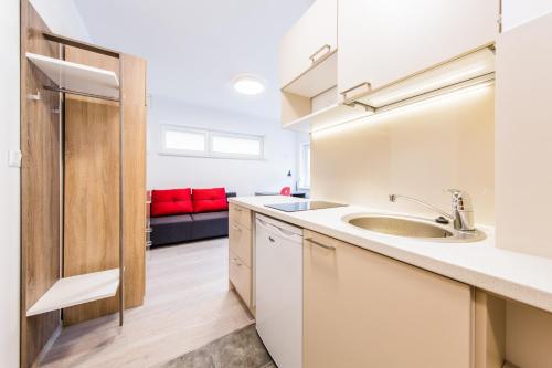 a kitchen with a sink and a counter top at HomeKoko Apartments in Katowice