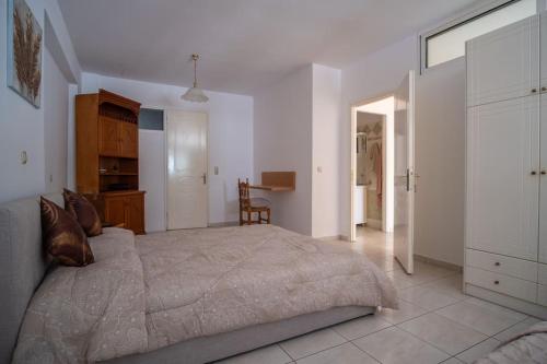 a bedroom with a large bed in a room at Thetis Luxury Apartment in Samos