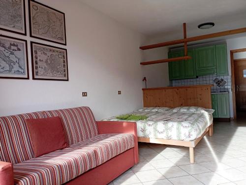 a living room with a couch and a bed at THE LITTLE NEST in Valdisotto
