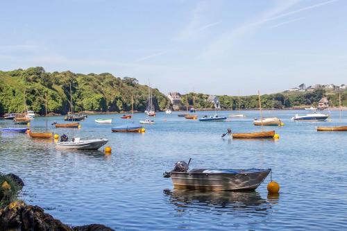 a bunch of boats in a large body of water at White Horses a large family home in Bantham South Devon with fantastic sea views in Bantham