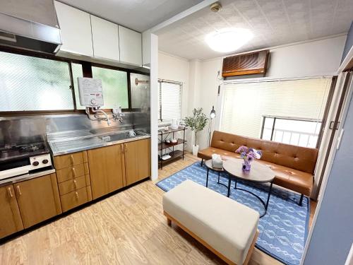 a small kitchen with a table and a couch at Japanese House-ueno/asakusa/oshiage/ginza/narita in Tokyo