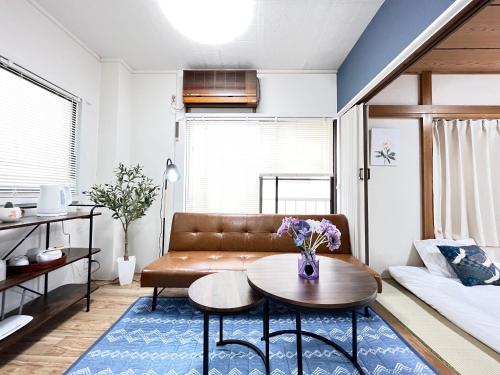 a living room with a couch and a table at Japanese House-ueno/asakusa/oshiage/ginza/narita in Tokyo