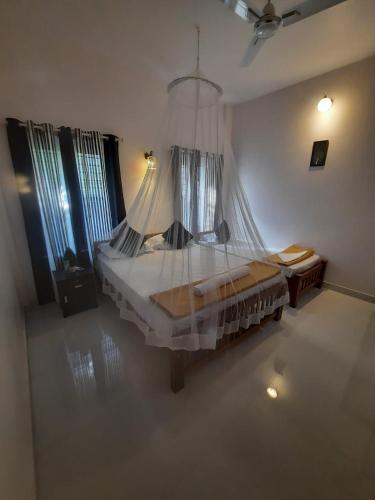 a bedroom with a large bed with a chandelier at CLIFF HEAVEN in Varkala