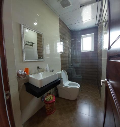a bathroom with a sink and a toilet at The Light Hotel in Da Lat