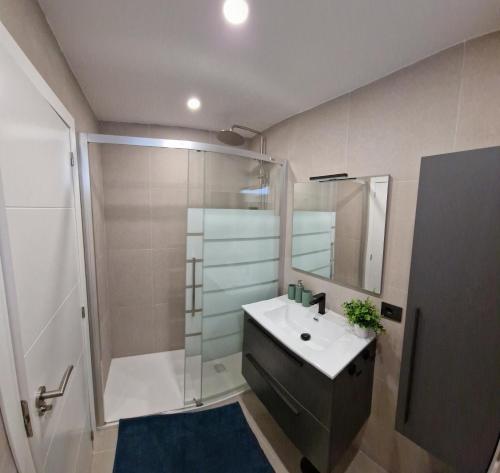 a bathroom with a sink and a shower at El Dorado Las Americas WiFi Pool in Arona
